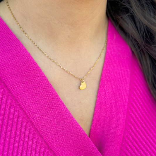 Gold necklace with single heart charm